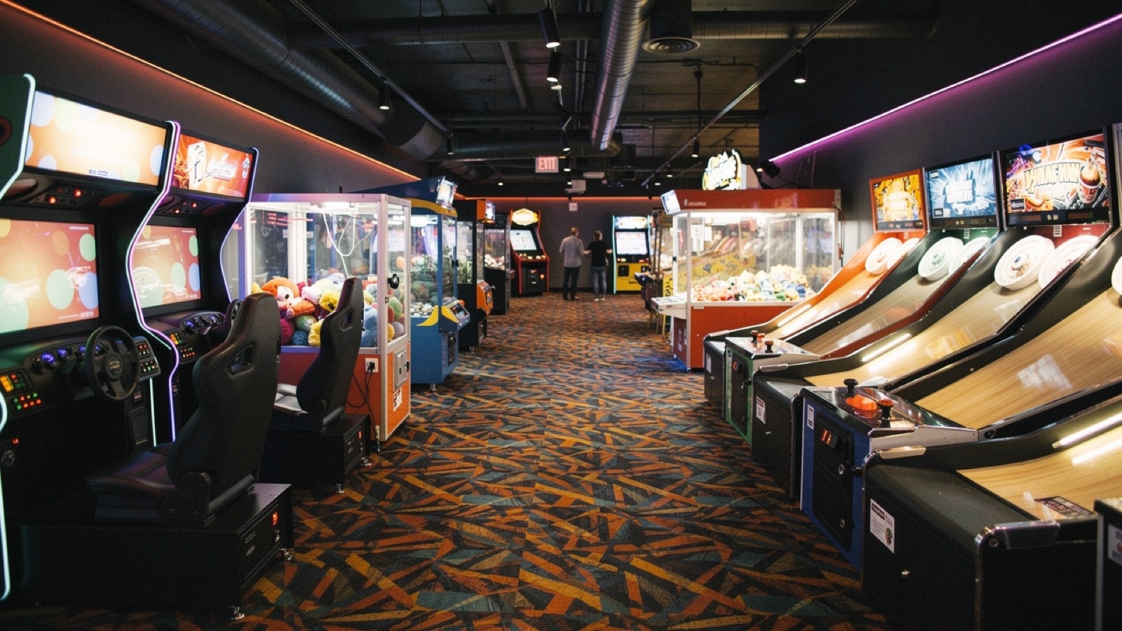 Concept rendering of the games alley — varied cabinets and lanes down a patterned carpet, deep perspective