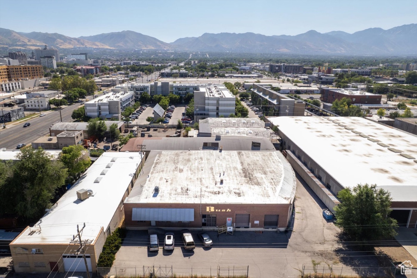 Aerial photo of the real warehouse campus and its fenced yard, looking toward downtown Salt Lake City